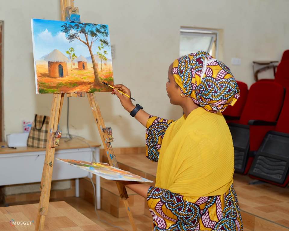 Build Her Art Project — young woman painting at an easel
